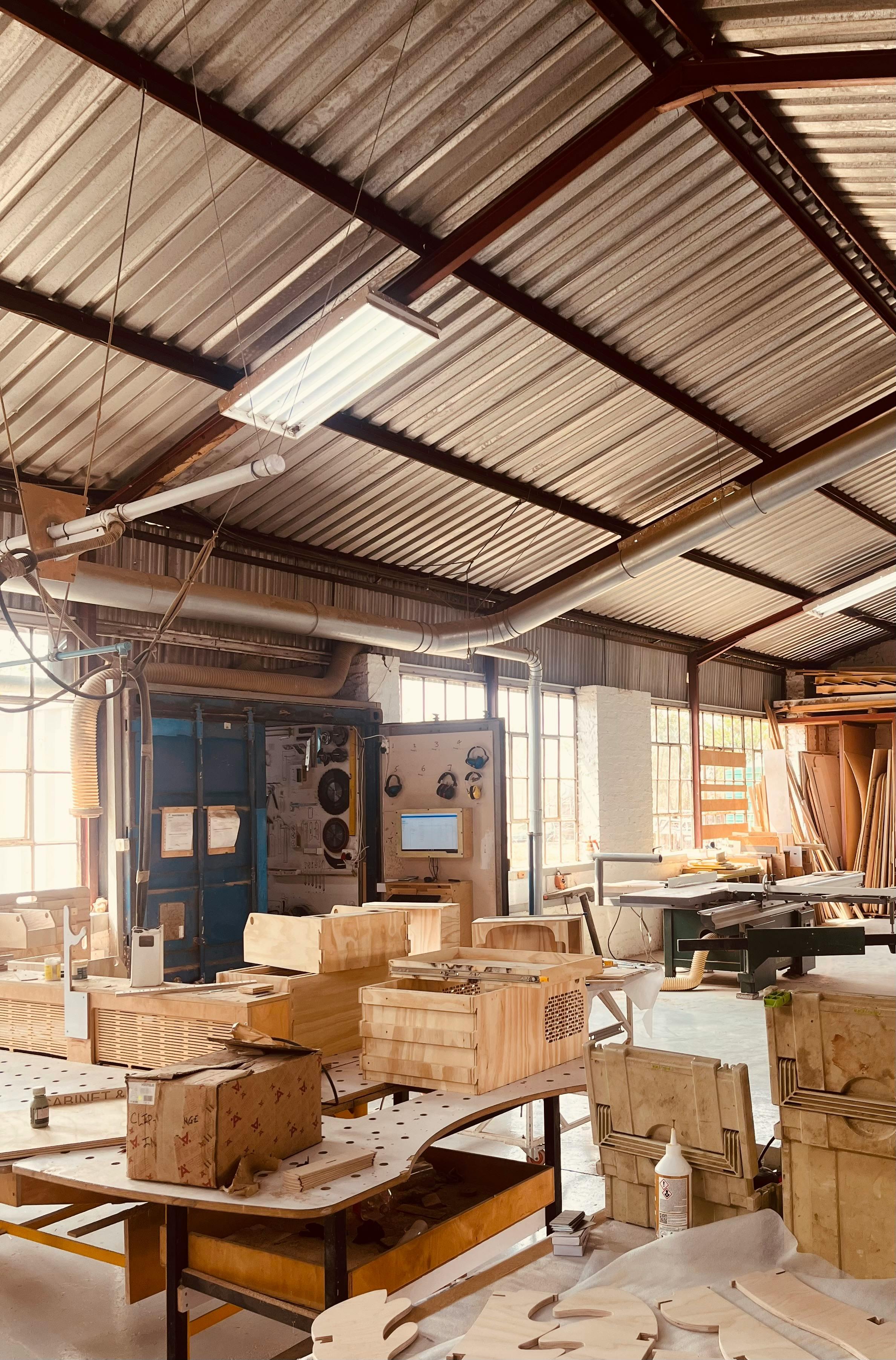 Carpenter working with wood in workshop creating custom furniture